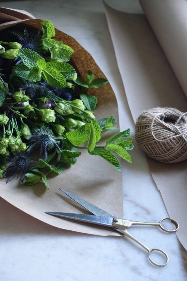 Wrapped bouquet of flowers in brown paper